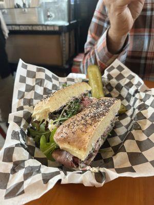 Roast beef sandwich with olive tapenade, arugula, thinly sliced beef, tomatoes and mayo/aioli - definitely get this!