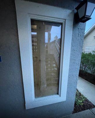 Broken glass and boarded up window