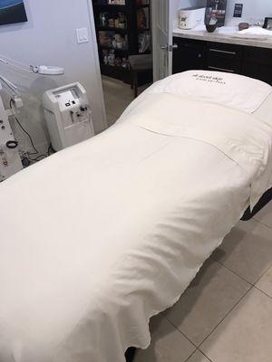 Facial treatment bed at All About Skin