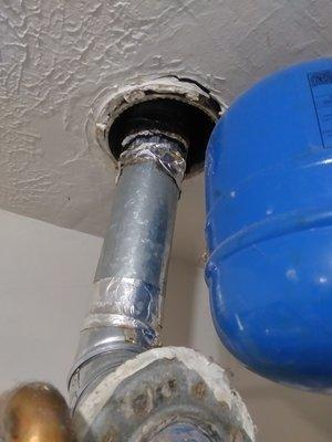 Hot water heater pipe hangs loosely and when it rains water drips inside the washroom.