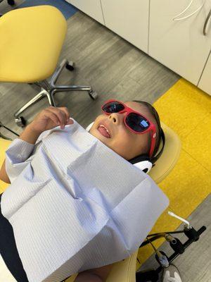 My son getting his teeth cleaned while watching a show :)