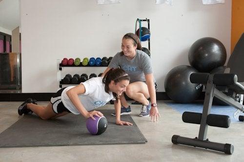 Owner, Lauren Cruz, training a client toward achieving her strength building goals.