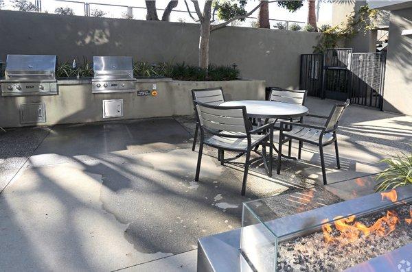 The outdoor area is an entertainer's dream, with a glass firepit, built-in BBQ, and a sparkling pool and spa.