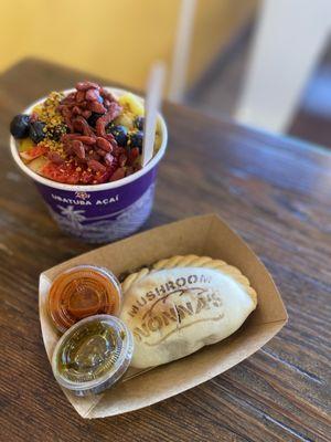 Açaí bowl with all toppings and mushroom empanada