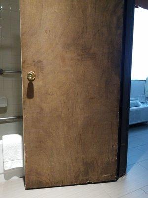 Bang up bathroom door looks like a left over from the shining.