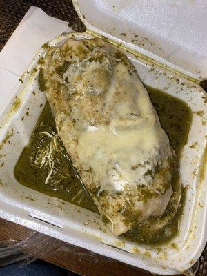 Chicken burrito with salsa Verde and cheese on top