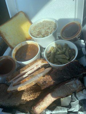 Ribs, brisket, turkey, baked beans (the best), dirty rice, green beans, bbq sauce & buttered bread.