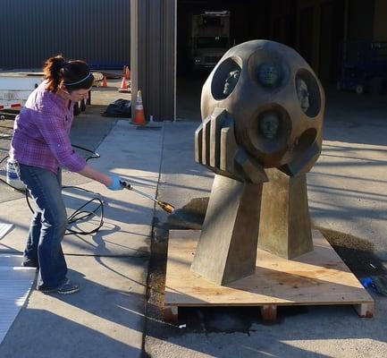 SF Art Conservation Director and Principal Conservator, Rowan Geiger, applies a hot wax coat to a bronze sculpture by Tony Smith