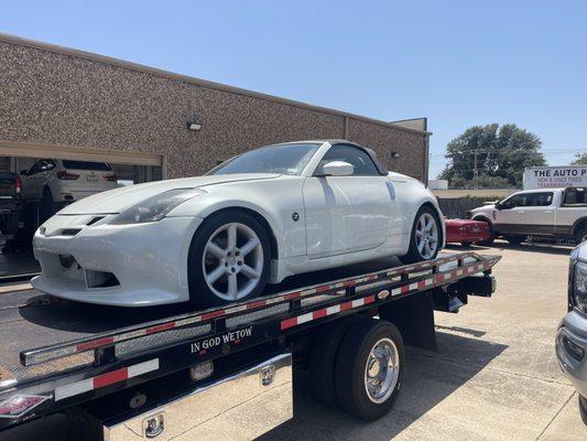 A beautiful white coupe rests on our flatbed