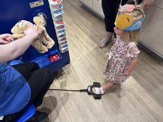 Filling up her bear with stuffing