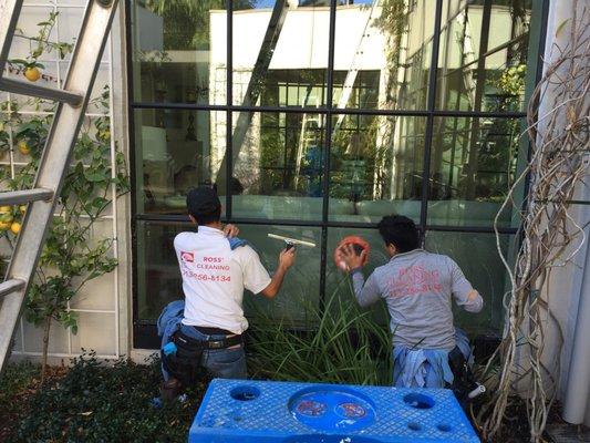 Window cleaning by hand.