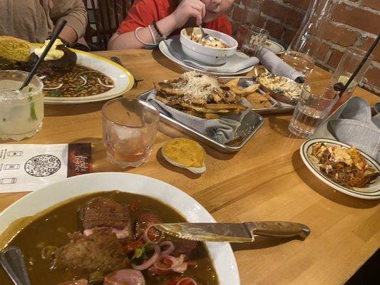 The full spread. Duck gumbo. Pork shoulder. Lasagna. Truffle fries and the Oh brother where art thou craft bourbon and noir cocktail.