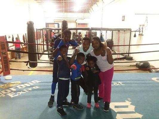 Coach with youth after boxing combat training.