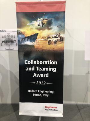 A banner representing their collaboration award.