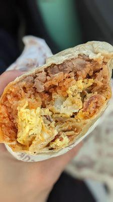 Breakfast burrito with eggs, bacon, potato, cheese ,rice and beans