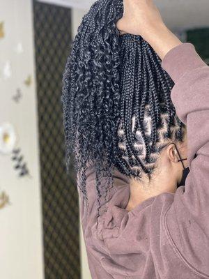 Medium Knotless Plaits with curls on the ends .