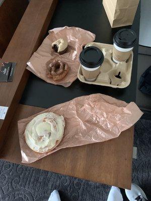 Cinnamon roll, old fashioned with chocolate frosting, and chocolate donut with maple frosting.