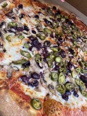 Extra large pizza with mushrooms olives jalapeños