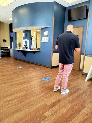 July 2021: Two staffers are manning the registration desk. (Dude was not moving:)