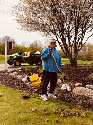 Becky from the P.F. Grounds Crew prepares the flower beds for the 2021 season.