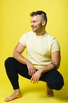 Armen posing looking to the left for the yoga studio opening