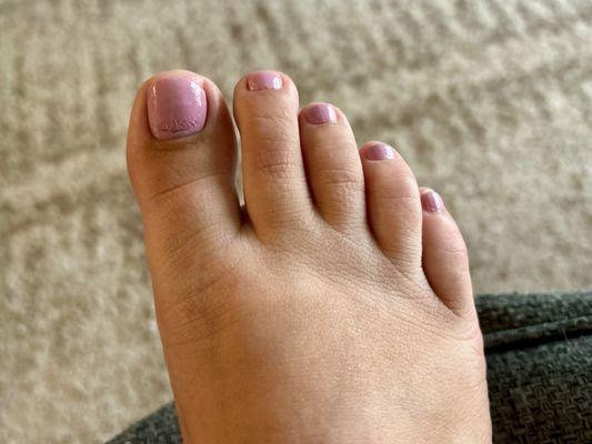 $50 dry pedicure with regular polish. You can see where the top coat ends and doesn't cover the full nail.