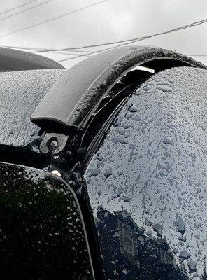 Roof trim damage caused by Ourisman auto car washer.