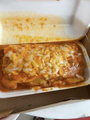 Wet Carne Asado burrito with beans tomatoes, cheese, and onions.