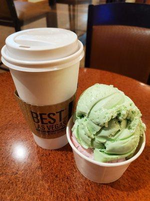 Pistachio and strawberry in a cup with a large coffee