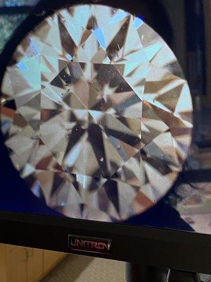 Magnified diamond: round 1.8 carat, F color, SI2 clarity, Excellent cut