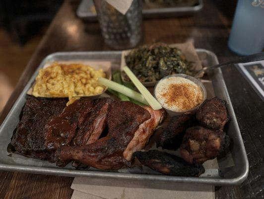 Three meat plate with macaroni and cheese and collard greens