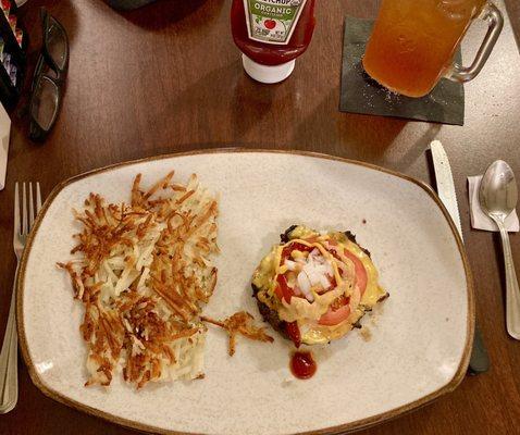 Bunless Akaushi beef cheeseburger, w/ American cheese, tomato, onions, mustard, ketchup, house aioli, and a side of hash browns.