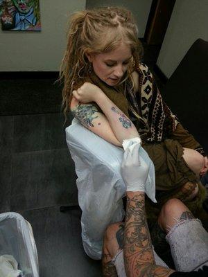 Daughter getting her portion of Father/Daughter tattoo.