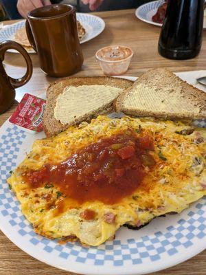 Meat lovers omelette and wheat toast.