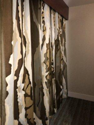 These were strange curtains that hid a window that looked out over the lobby.