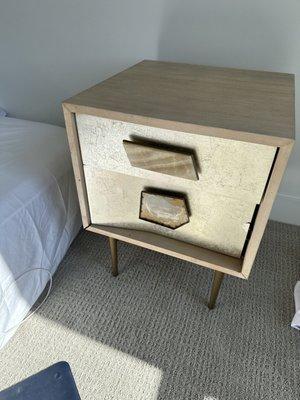 Bashed in metal nightstand