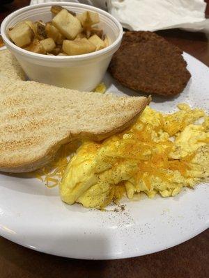 Scrambled two egg breakfast with hash browns and sausage