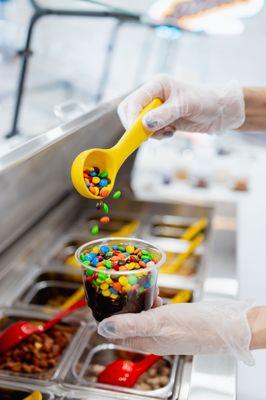 Adding toppings to a customer's order.