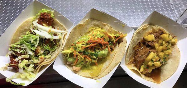 Three different tacos. A Korean Buffalo chicken, a chicken curry, and a slow cooked pork.