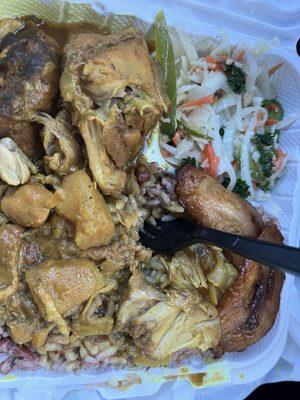 Curry chicken dinner with cabbage, rice and peas and plaintain