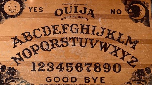 A unique ouija coffee table. It is located in the common area, on the second floor.