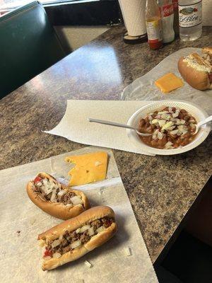 Hotdogs with chili. Sliced cheese. Beans with onions.