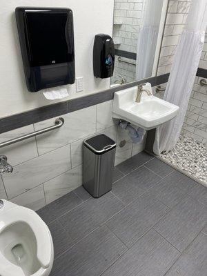 Beautiful and clean individual unisex bathroom with a shower