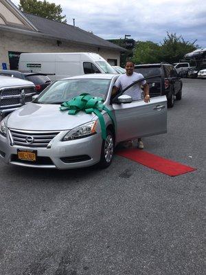 My son getting into his new car from the Red Carpet enterprise laid on the ground.