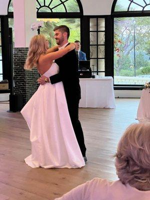 Bride and groom first dance, Matt in the background.