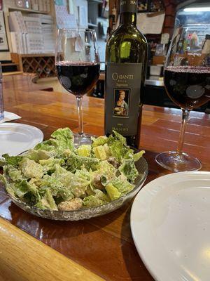 Caesar salad. Bottle of excellent Chianti