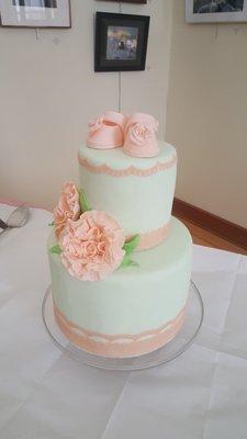 Baby shower cake of dreams: white cake with fresh fruit covered in peach and mint fondant