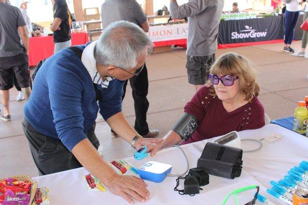 Tante taking BP and O2 sats at the ALS Walk.