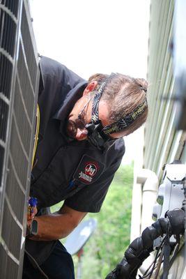 Fallon checking his gauges on the outdoor unit while performing a comfort club maintenance