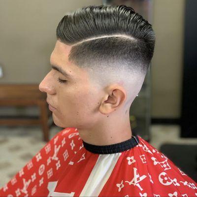 Mid fade line up and hard part with a comb over